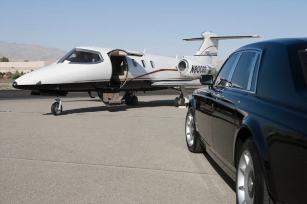 Car next to private jet